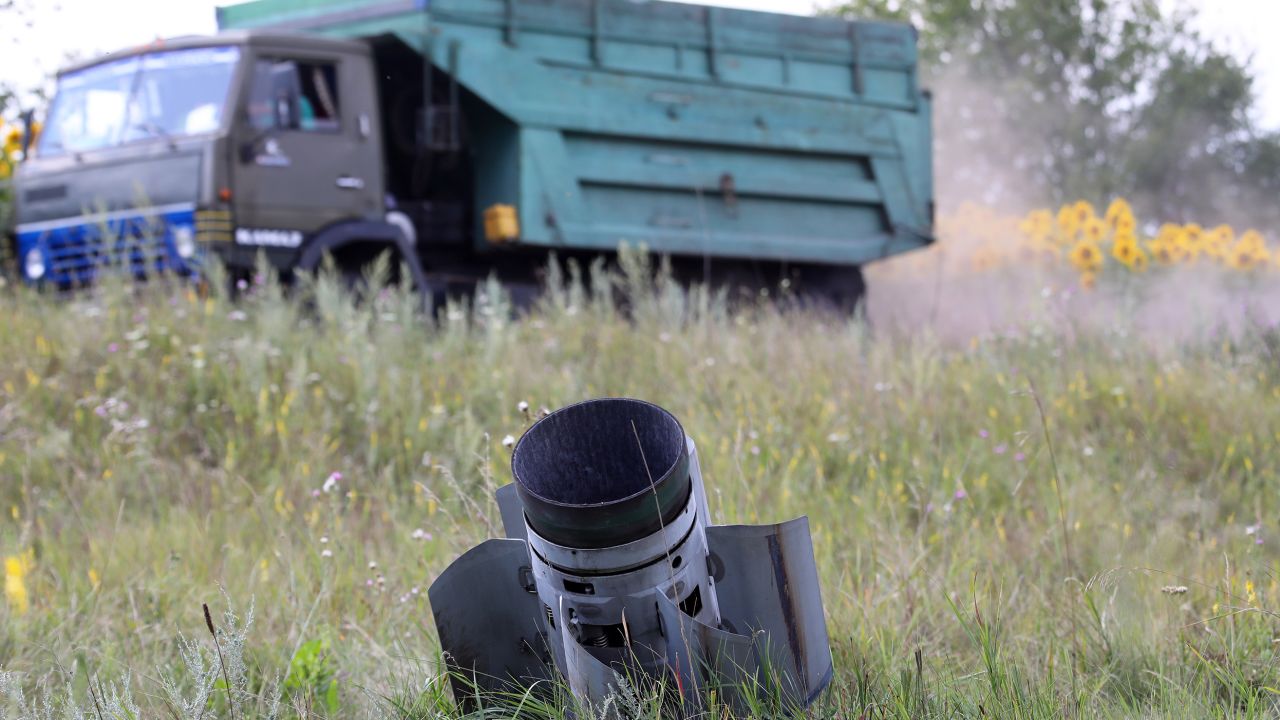 KHARKIV REGION, UKRAINE - JULY 30, 2022 - A Russian missile is stuck in the ground as the harvest season is underway in the northern part of the region despite Russian shelling, Kharkiv Region, northeastern Ukraine. This photo cannot be distributed in the Russian Federation. (Photo credit should read Vyacheslav Madiyevskyy/ Ukrinform/Future Publishing via Getty Images)