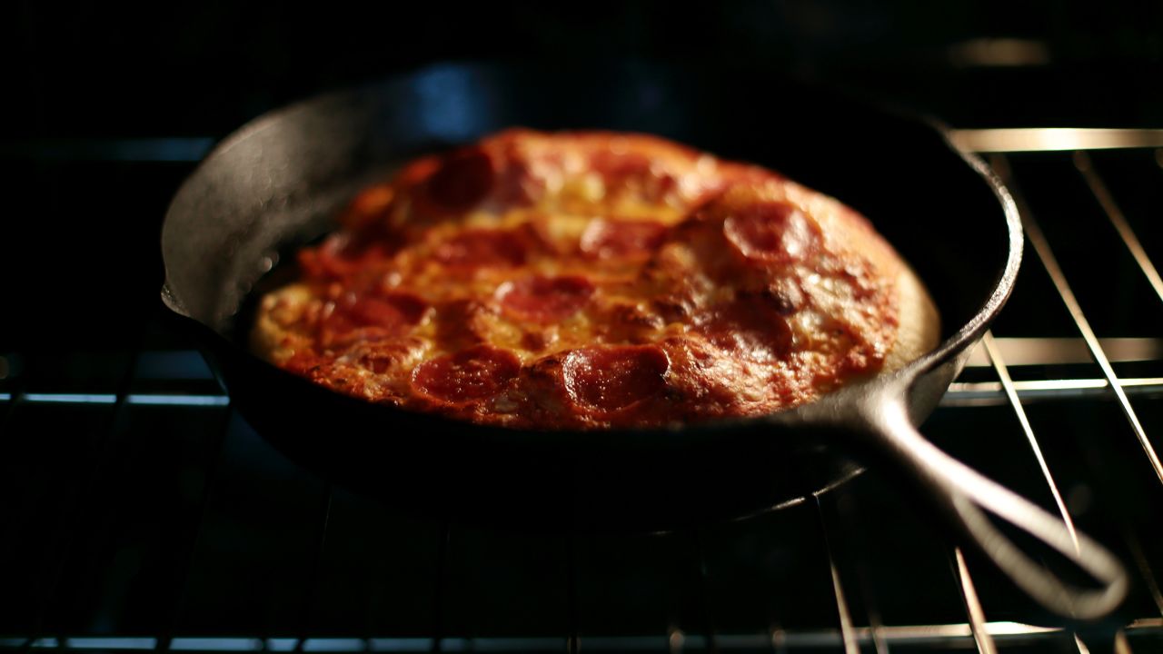 Preheating a cast-iron skillet in the oven gives dough a sizzling surface that helps the pizza puff up.