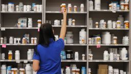 A pharmacy technician grabs a bottle of drugs off a shelve at the central pharmacy of Intermountain Heathcare on September 10, 2018 in Midvale, Utah. 
