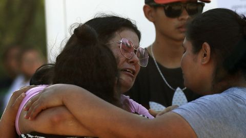 Relatives of a miner cry.