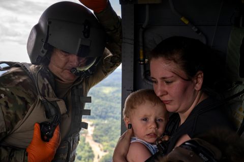 Tim Lewis of the Kentucky National Guard secures Candace Spencer and her son Wyatt after being airlifted from South Fork, Kentucky, on Saturday, July 30. Heavy rain led to <a href="https://www.cnn.com/2022/07/29/weather/gallery/kentucky-flooding/index.html" target="_blank">widespread flooding in eastern Kentucky.</a> At least 37 people are dead, and rescue workers continue to search for those who are missing. Hundreds of people have lost everything they have.