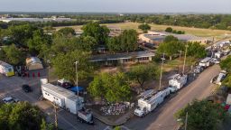 This aerial view, shows Robb Elementary School and the makeshift memorial (C, Bottom) for the shooting victims in Uvalde, Texas, on May 28, 2022. - Director of the Texas Department of Public Safety Steven C. McCraw said May 27 that in "hindsight" it was the wrong decision for police not to immediately breach the Uvalde classroom where a gunman ultimately shot dead 19 children and two teachers. 