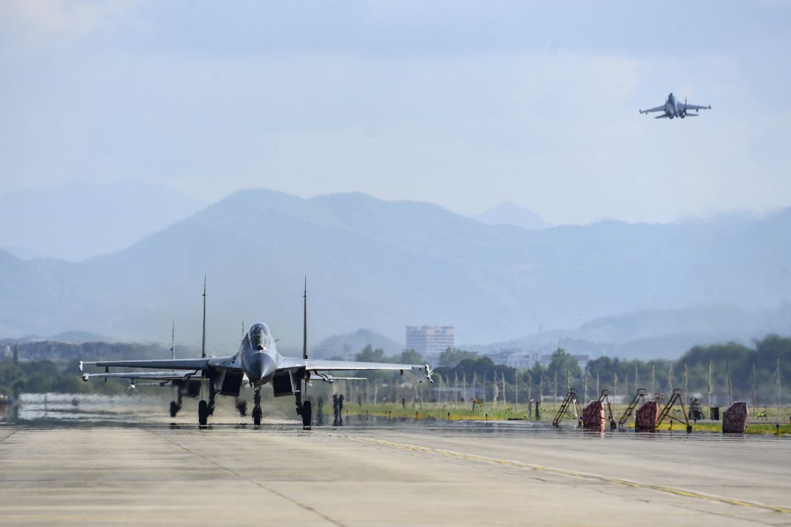Chinese air force and naval aircraft fly at an unspecified location in China on August 4.