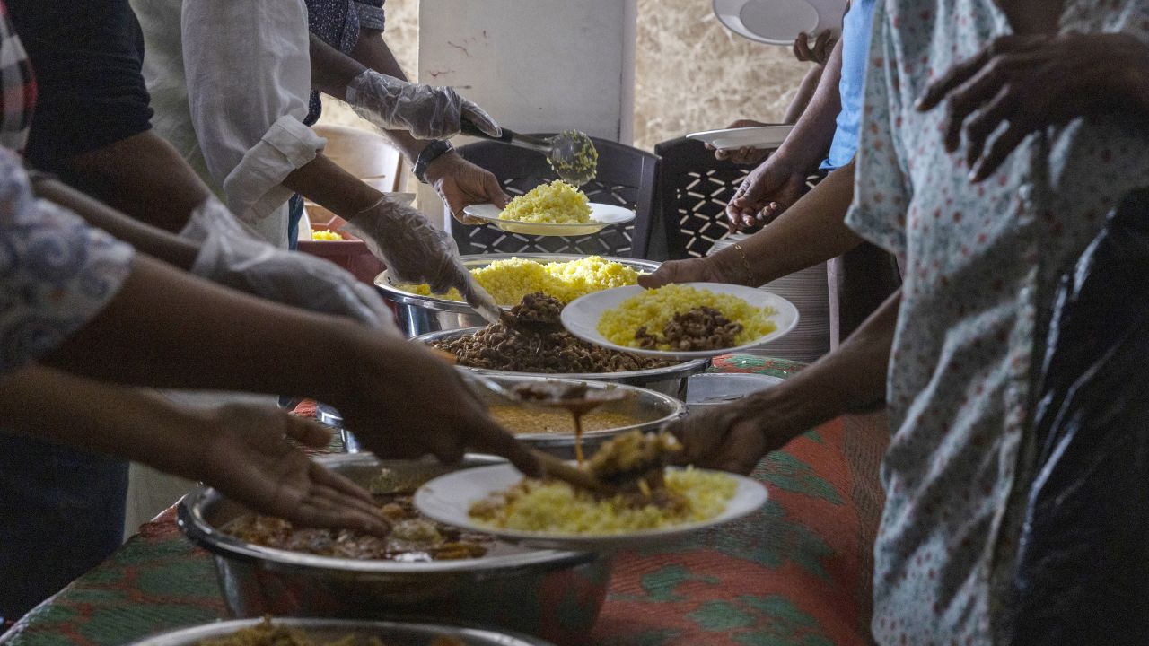 Volunteers serve free meals to people in need at a community kitchen in Colombo, Sri Lanka on Aug. 4.