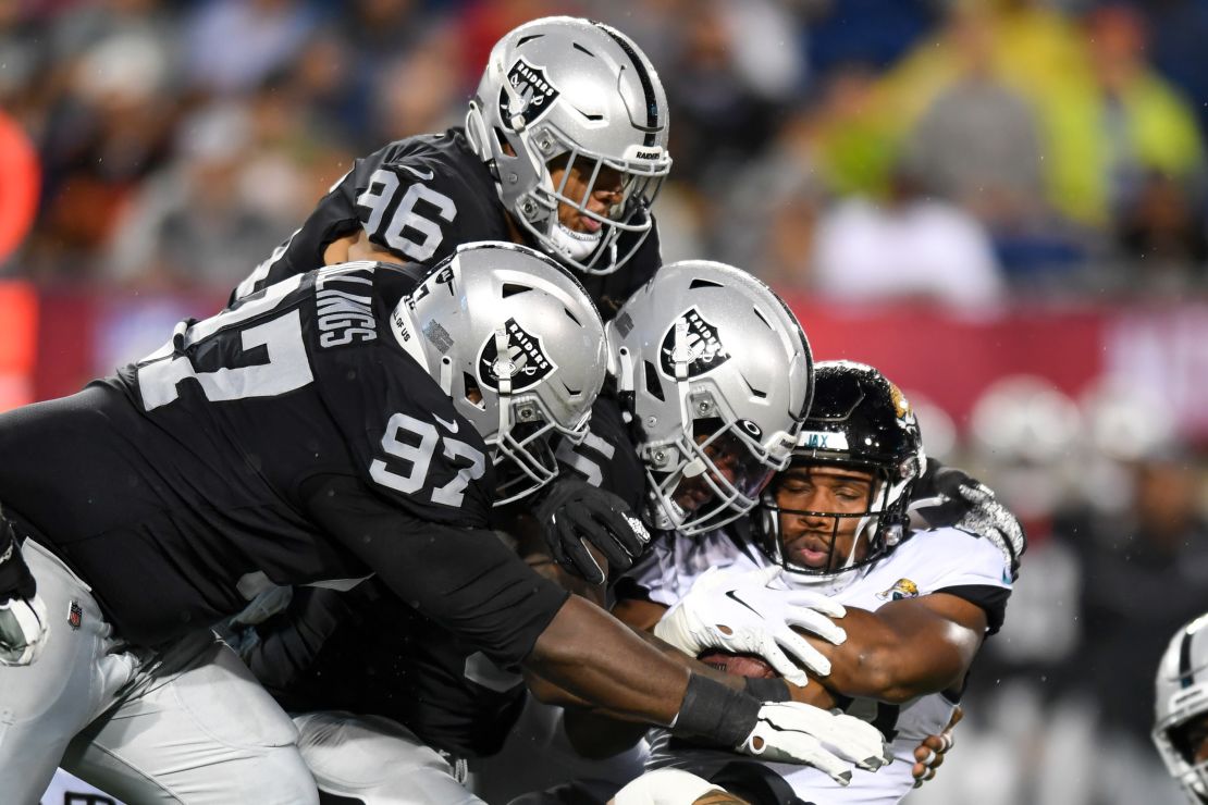 Snoop Conner is tackled by Kendal Vickers, Andrew Billings and Tashawn Bower. 