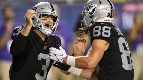 Las Vegas Raiders quarterback Jarrett Stidham celebrates with tight end Jacob Hollister after scrambling for a touchdown during the first half against the Jacksonville Jaguars.