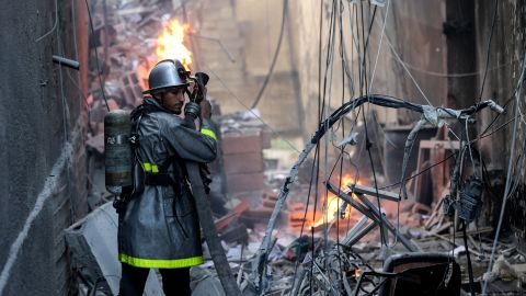 A Palestinian firefighter fights the blaze amid the destruction following an Israeli air strike on Gaza City, on August 5, 2022.
