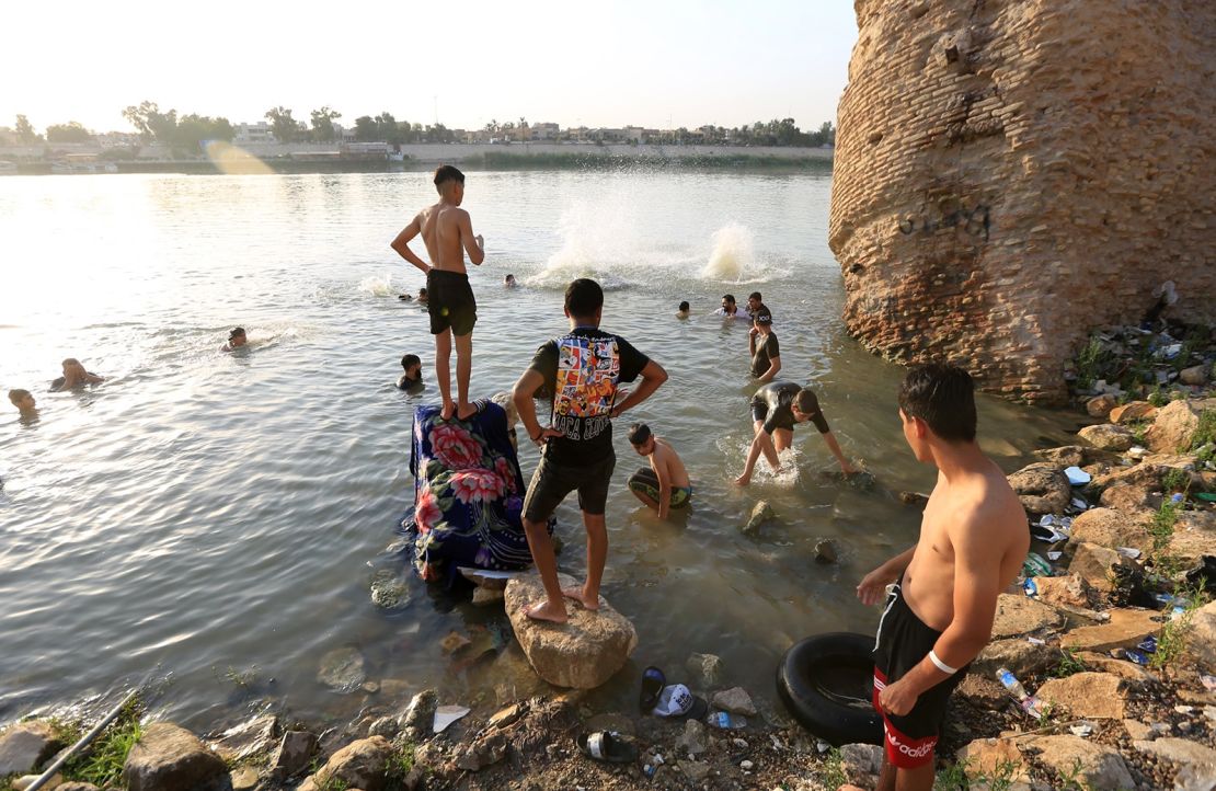 People cool off at the Tigris River during hot weather in Baghdad, Iraq on August 4.