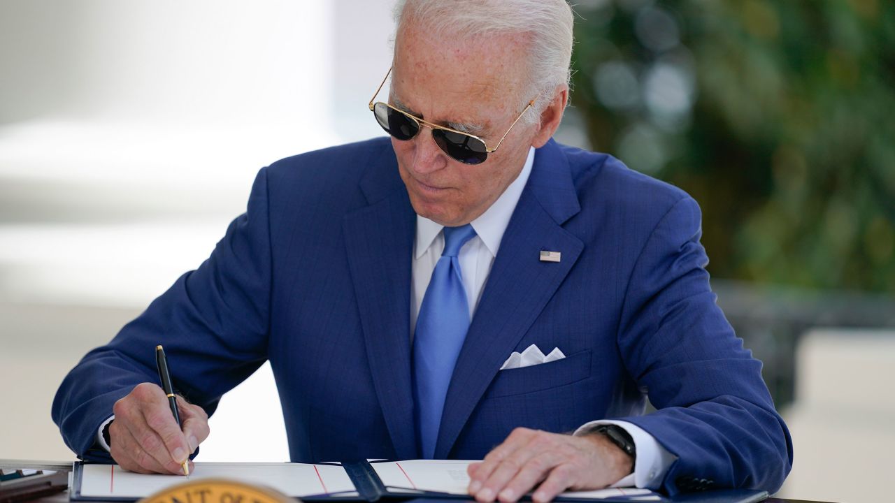 President Joe Biden signs two bills aimed at combating fraud in the COVID-19 small business relief programs Friday, Aug. 5, 2022, at the White House in Washington. 