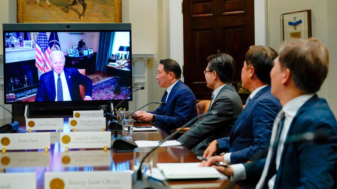 President Joe Biden appears on screen as he listens to SK Group Chairman Chey Tae-won, fourth from right, speak during a virtual meeting in the Roosevelt Room of the White House in Washington, Tuesday, July 26, 2022. The meeting comes as the Biden administration is seeking the cooperation of Asian allies such as South Korea to reinforce supply chains for critical components such as semiconductors. (AP Photo/Susan Walsh)