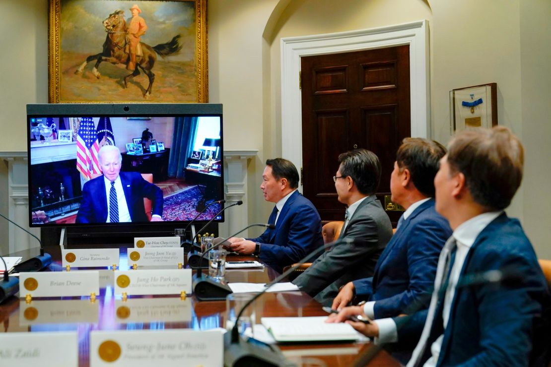 President Joe Biden appears on screen as he listens to SK Group Chairman Chey Tae-won, fourth from right, speak during a virtual meeting in the Roosevelt Room of the White House in Washington, Tuesday, July 26, 2022. The meeting comes as the Biden administration is seeking the cooperation of Asian allies such as South Korea to reinforce supply chains for critical components such as semiconductors. (AP Photo/Susan Walsh)