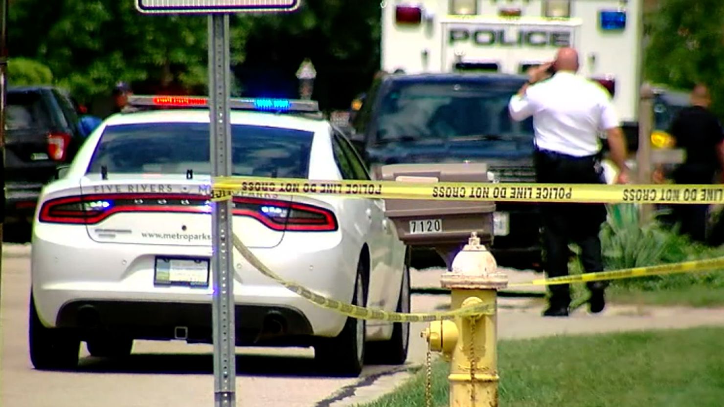 Police at one of the crime scenes on Friday after four people were fatally shot at multiple sites in a small town north of Dayton, Ohio. 