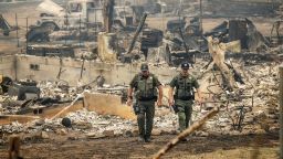 Sheriff's deputies leave a home where a McKinney Fire victim was found on Monday, Aug. 1, 2022, in Klamath National Forest, California. (AP Photo/Noah Berger)