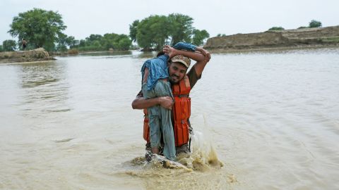 A Pakistani soldier rescues a child from the flooded Rajanpur district, Punjab province, on August 2.