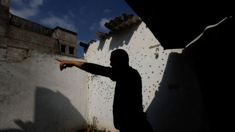 A Palestinian man inspects a damaged house in the northern Gaza Strip on Saturday.