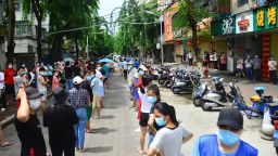 People line up for nucleic acid testing in the street as Sanya imposes city-wide static control to curb new COVID-19 outbreak on August 6, 2022 in Sanya, Hainan Province of China. 