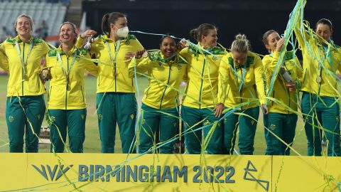 Gold medalists  Australia, including Tahlia McGrath (third from left, wearing a face mask), stand on the podium during the medal ceremony.