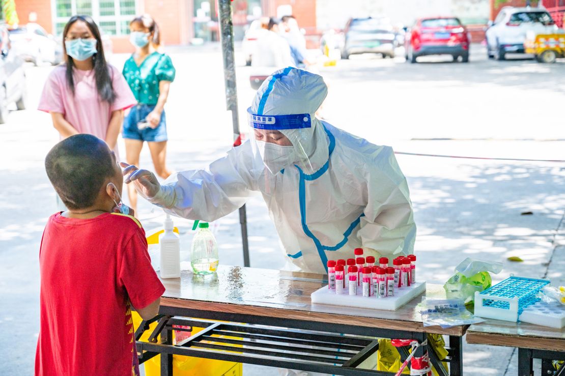 A medical worker conducts Covid testing for a child on August 7 in Sanya.