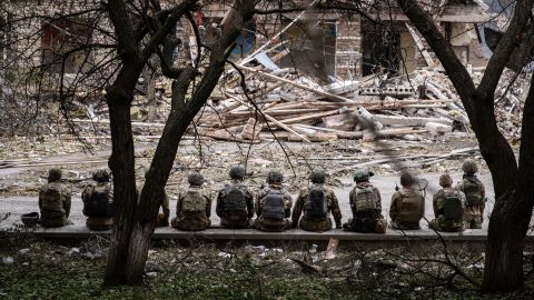 Ukrainian soldiers sit at the shelling scene of a destroyed school in Kramatorsk.