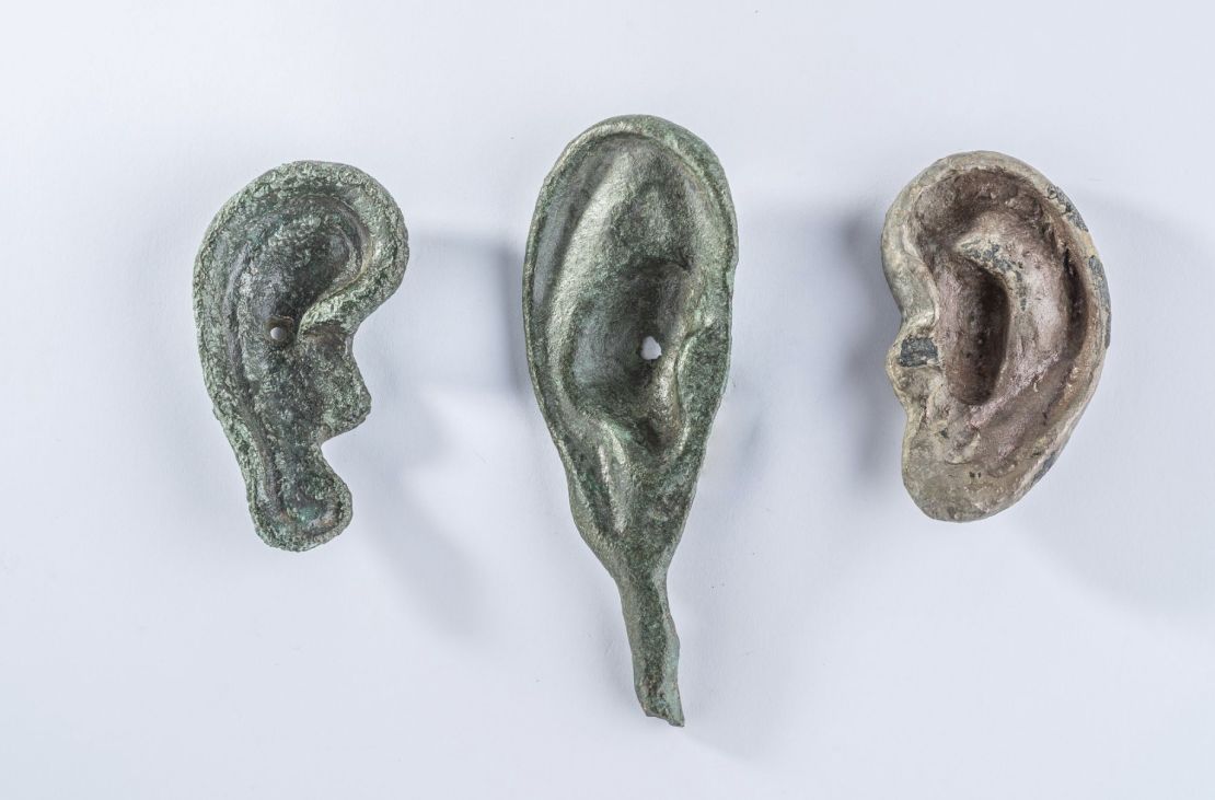 A collection of three ear-shaped votive offerings unearthed at San Casciano dei Bagni.