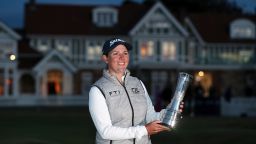 South Africa's Ashleigh Buhai poses for the media holding the trophy after winning the Women's British Open golf championship, during the presentation ceremony in Muirfield, Scotland, Sunday, August 7, 2022.