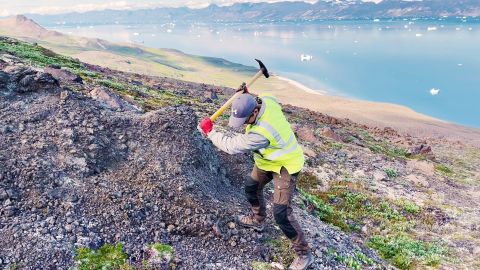 A Bluejay Mining employee digs during exploration for critical minerals in Greenland. 