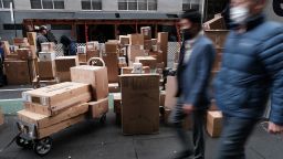 Dozens of packages are lined up along a Manhattan street as a FedEx truck makes deliveries on December 06, 2021 in New York City.