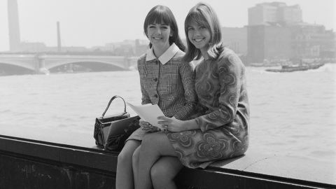 Newton-John and singing partner Pat Carroll pose for a photo in London in 1966. Newton-John recorded her first single in England in 1966 and scored a few international hits, but she remained largely unknown to US audiences until 1973, when "Let Be There" became a top-10 hit on both the adult contemporary and the country charts.