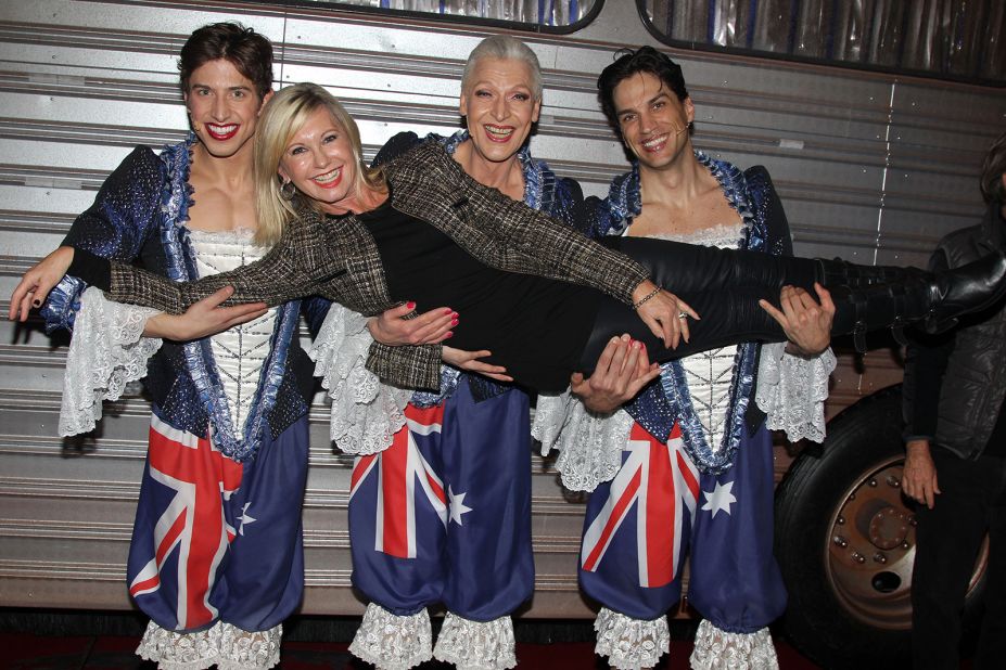 Newton-John is held by Nick Adams, Tony Sheldon and Will Swenson while attending the Broadway musical "Priscilla, Queen of The Desert" in 2011.