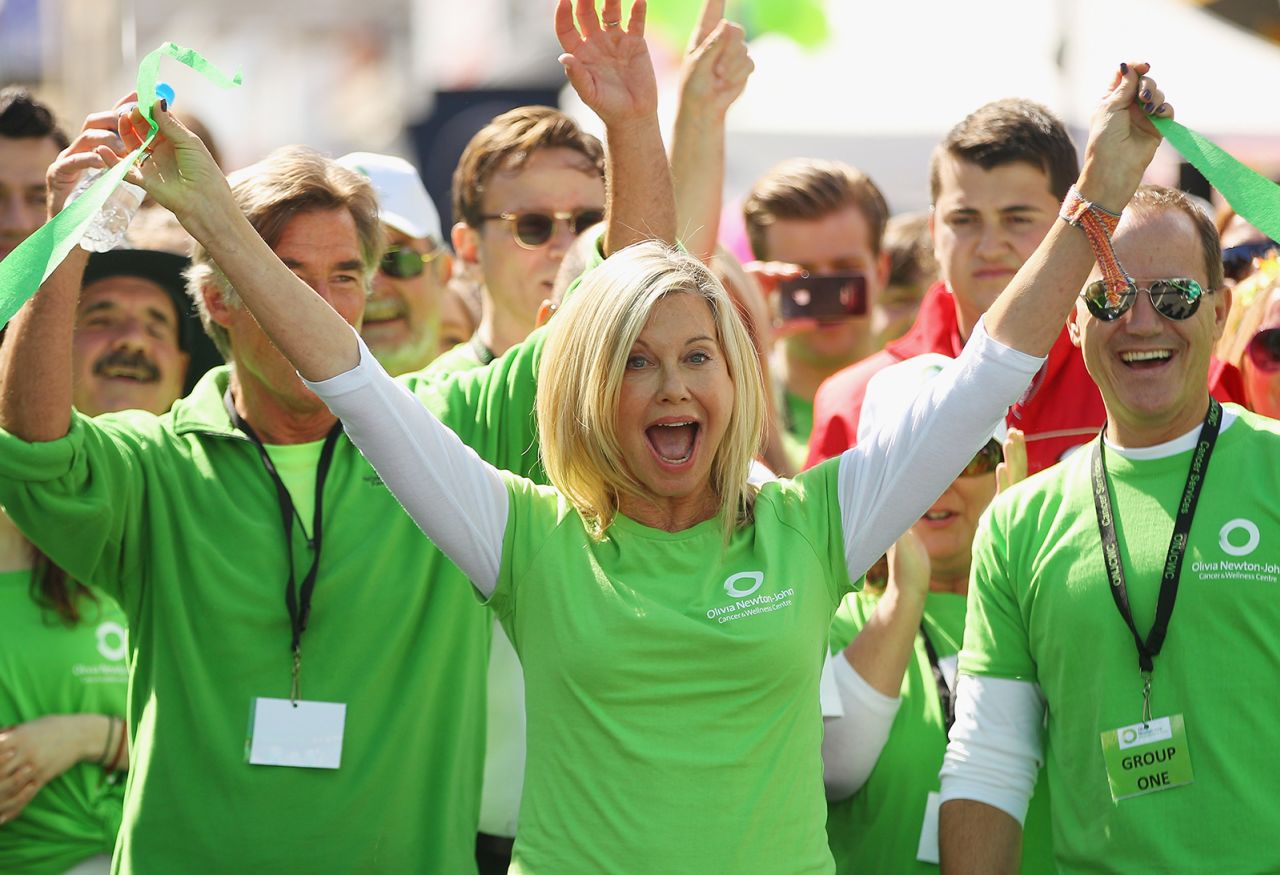 Newton-John celebrates at a charity walk in Melbourne in 2013. The event raised money for the Olivia Newton-John Cancer and Wellness Centre. 