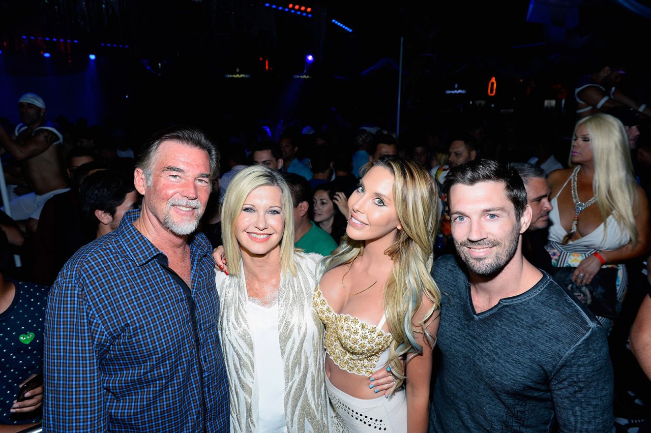 Newton-John poses with her second husband, John Easterling; her daughter, Chloe Lattanzi; and Chloe's fiance, James Driskill, in 2015. They were attending an event celebrating the 35th anniversary of "Xanadu."