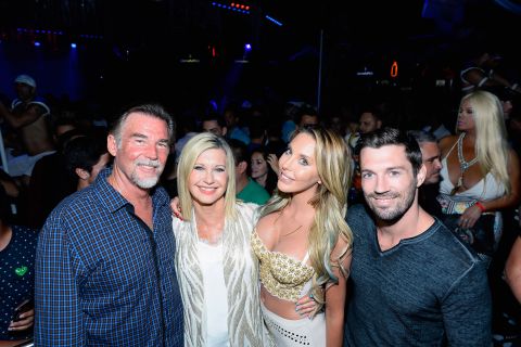 Newton-John poses with her second husband, John Easterling; her daughter, Chloe Lattanzi; and Chloe's fiance, James Driskill, in 2015. They were attending an event celebrating the 35th anniversary of 