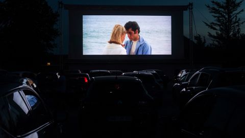 People in Ptuj, Slovenia, watch "Grease" at a drive-in movie theater in 2020.