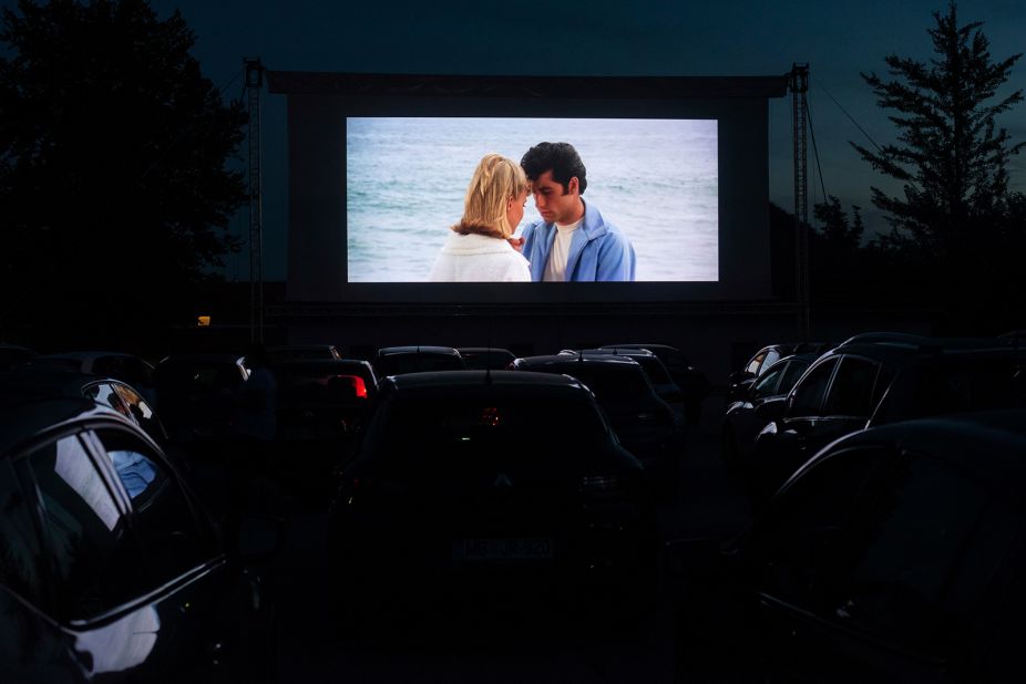 People in Ptuj, Slovenia, watch "Grease" at a drive-in movie theater in 2020.
