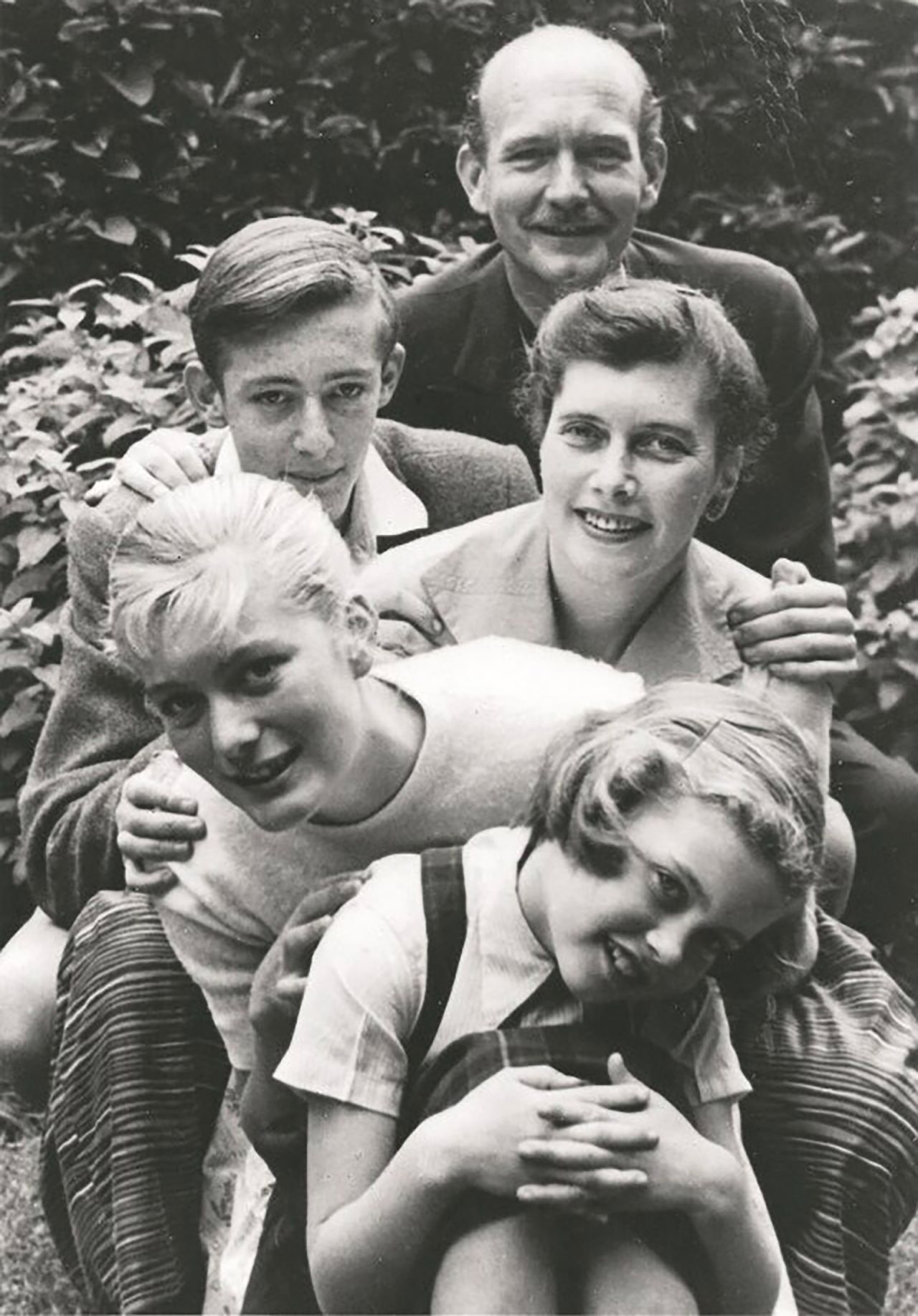 A young Newton-John is seen in front here with her father, Brin; her brother, Hugh; her mother, Irene; and her sister, Rona. Newton-John was born in Cambridge, England, in 1948. She moved with her family to Australia when she was 5.