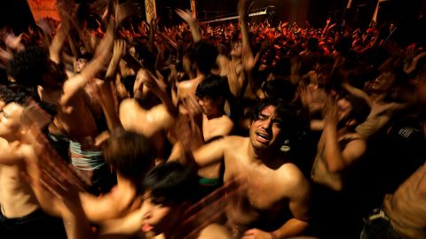 Iraqi Shiite Muslims take part in a ritual of mourning in Sadr City in eastern Baghdad late on August 7 to mark Ashura, a 10-day period commemorating the killing of the Prophet Mohammad's grandson Imam Hussein in the Battle of Karbala in 680 AD.