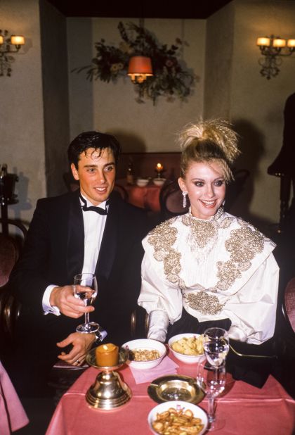Newton-John in a heavily embellished top and crimped hair at a dinner with former husband Matt Lattanzi Switzerland in 1984. 