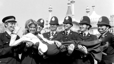 Newton-John is held by police officers in Brighton, England, where she was rehearsing for the 1974 Eurovision Song Contest.
