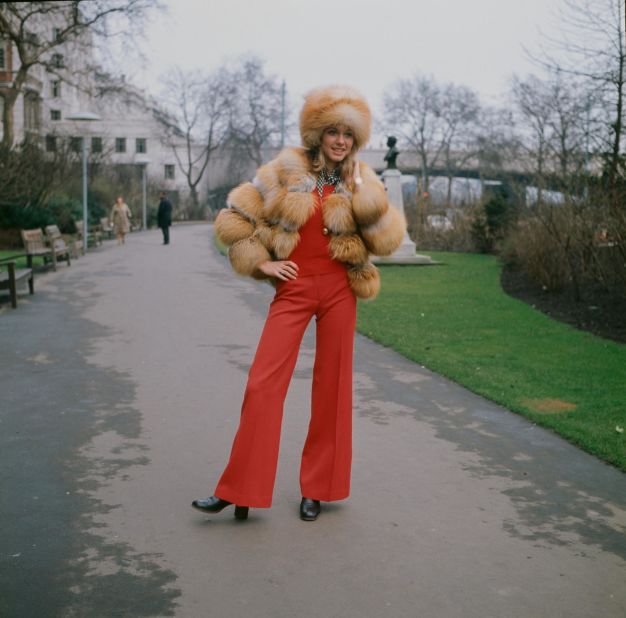 Olivia Newton-John, wearing a fur hat and jacket, outside the Savoy Hotel in London, circa 1970.