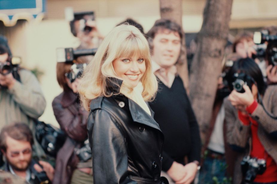 Newton-John attends a 1978 press conference in London in a Sandy-inspired leather jacket. 