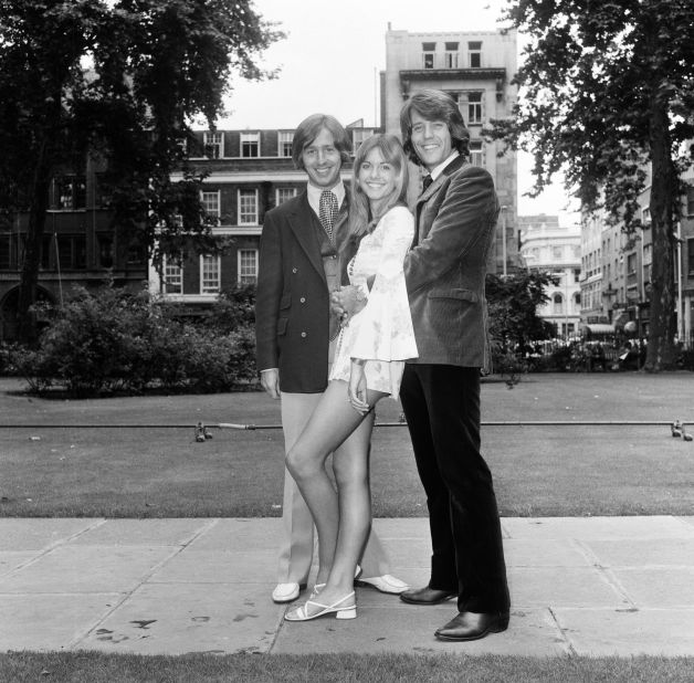 Newton-John, with her castmates Benny Thomas and Vic Cooper from the 1970 sci-fi musical film "Toomorrow," pictured in Soho Square, London in July 1970 in a dainty outfit with statement '70s sleeves. 