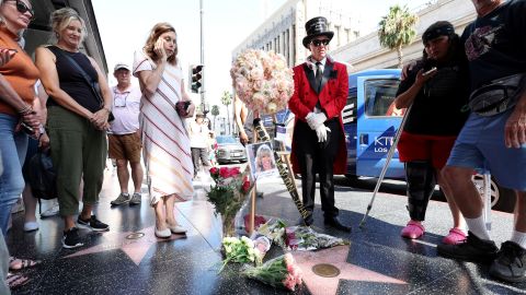 People lay flowers by the star of late actor Olivia Newton-John on the Hollywood Walk of Fame in Los Angeles, California.