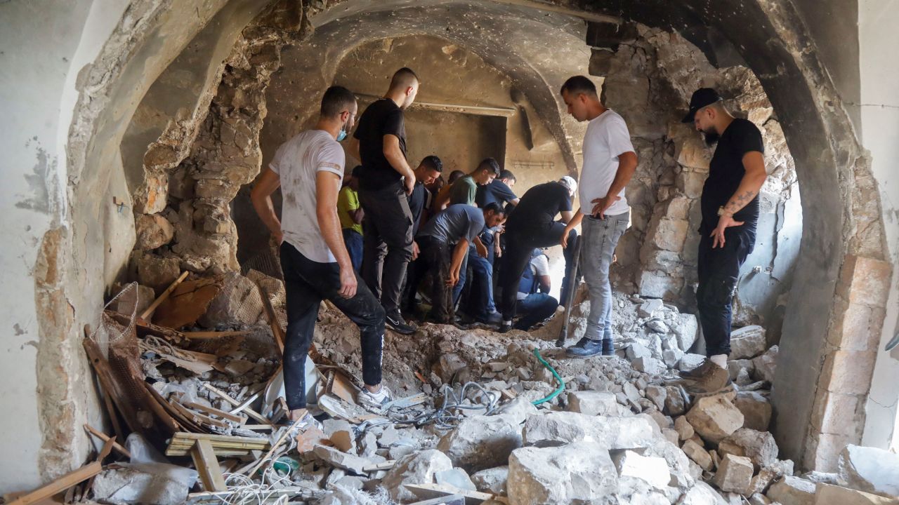 Palestinians inspect a building damaged during an Israeli military operation in Nablus on Tuesday. 