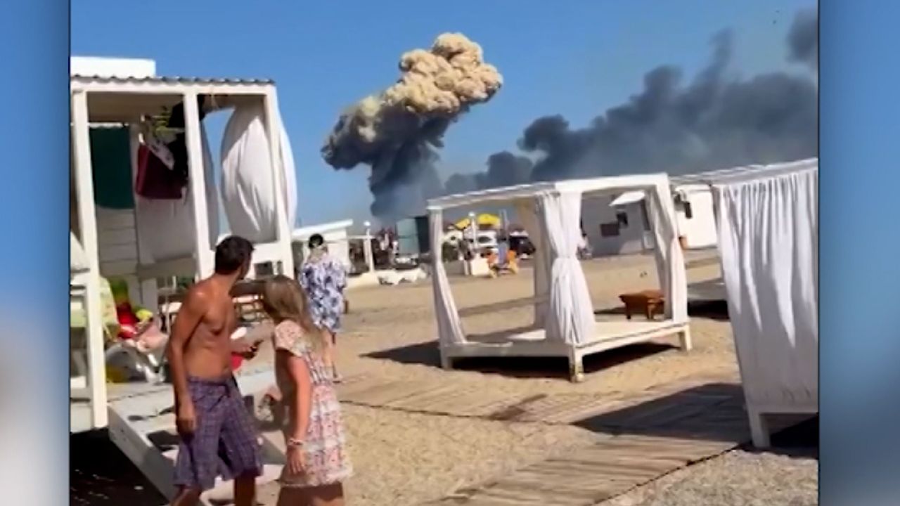 A mushroom cloud of smoke can be seen in the distance, scaring beachgoers in Crimea last week. 
