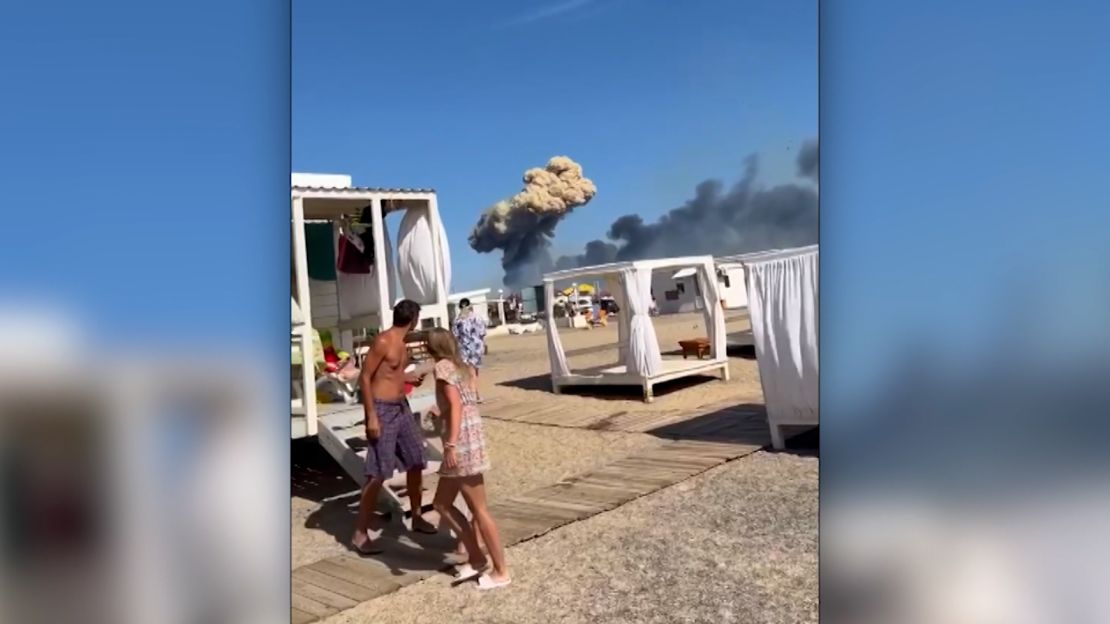 A mushroom cloud of smoke can be seen in the distance, scaring beachgoers in Crimea last week. 