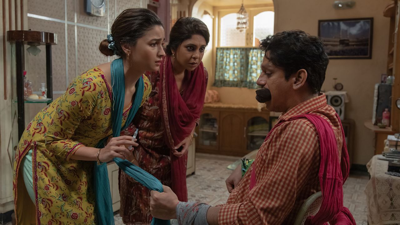 A promotional still from "Darlings" shows Alia Bhatt (left) with her co-stars Shefali Shah (center) and Vijay Varma (right).