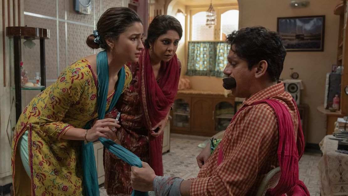 A promotional still from "Darlings" shows Alia Bhatt (left) with her co-stars Shefali Shah (center) and Vijay Varma (right).