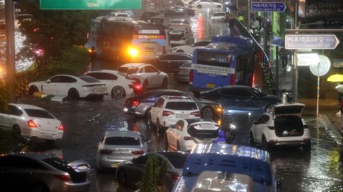 Abandoned cars fill the road in a flooded area during heavy rain in Seoul, South Korea, on August 8.