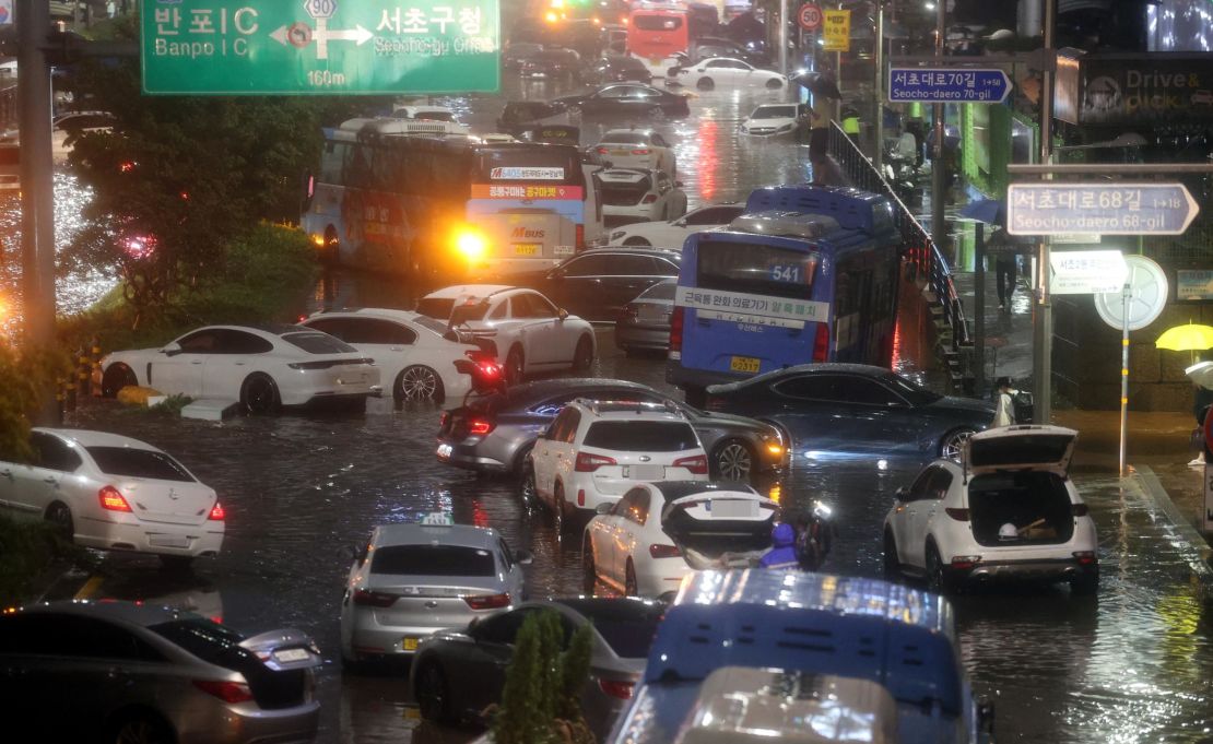Abandoned vehicles fill the road in a flooded area during heavy rain in Seoul, South Korea, on August 8.