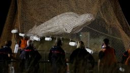 Firefighters and members of a search and rescue team pull up a net as they rescue a Beluga whale which strayed into France's Seine river, near the Notre-Dame-de-la-Garenne lock in Saint-Pierre-la-Garenne, France, August 10, 2022. REUTERS/Benoit Tessier     TPX IMAGES OF THE DAY